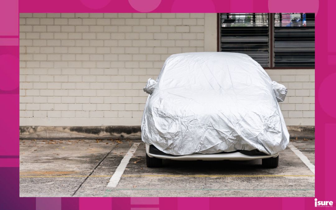 A car is parked with a cover on it, showing it as currently unused. Without a driver's licence, you may still insure a car that is unused.