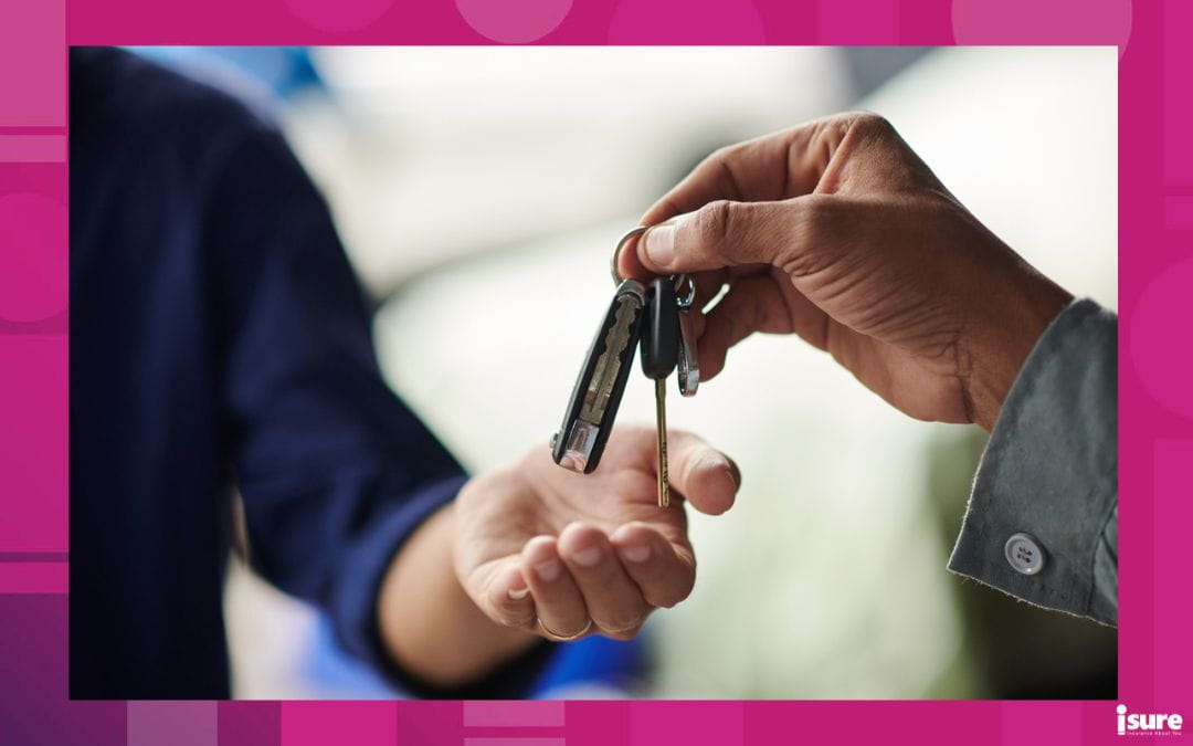 A hand hands a pair of car keys to another driver, placing them in their hand.